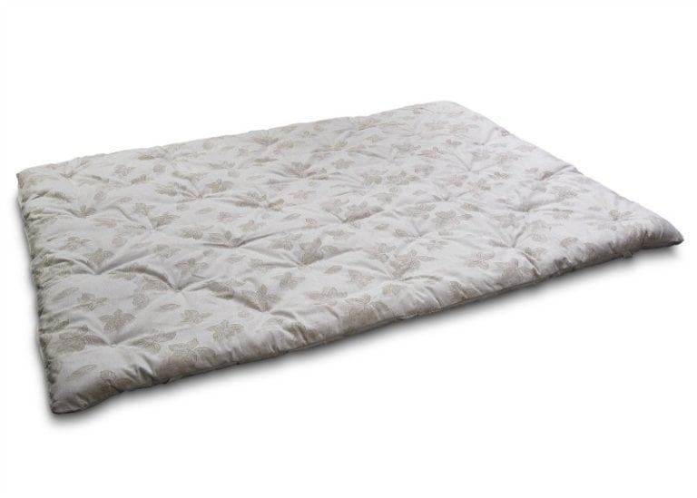 Outstretched wool-filled mattress pad with a tufted, neutrally colored floral print.