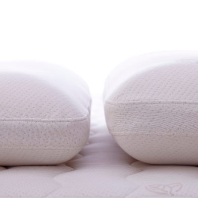 Two latex pillows side by side showing the difference in heights.