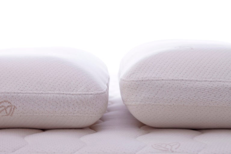 Two latex pillows side by side showing the difference in heights.